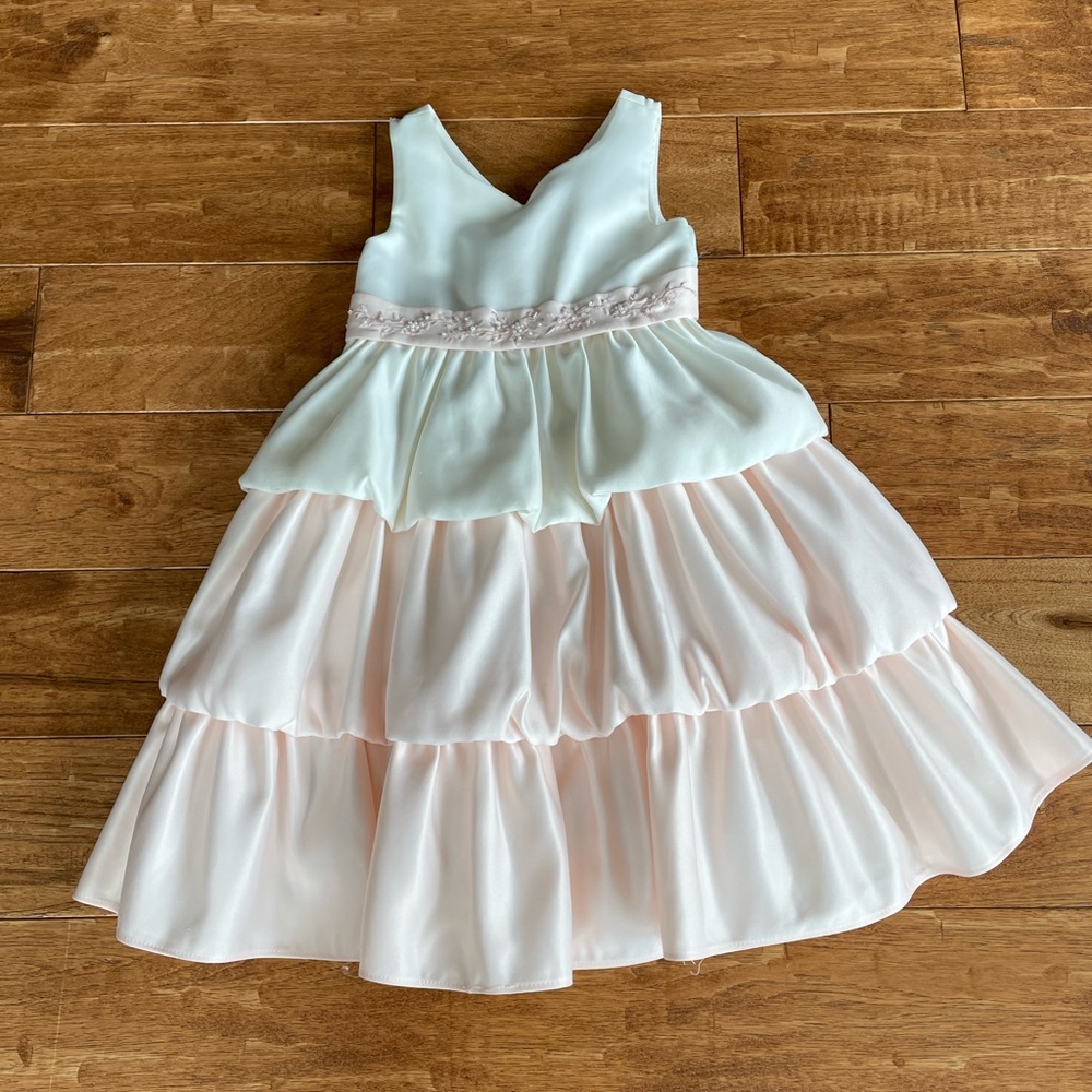 Beautiful formal girls’ dress with tulle and layers of silky tufted skirting.